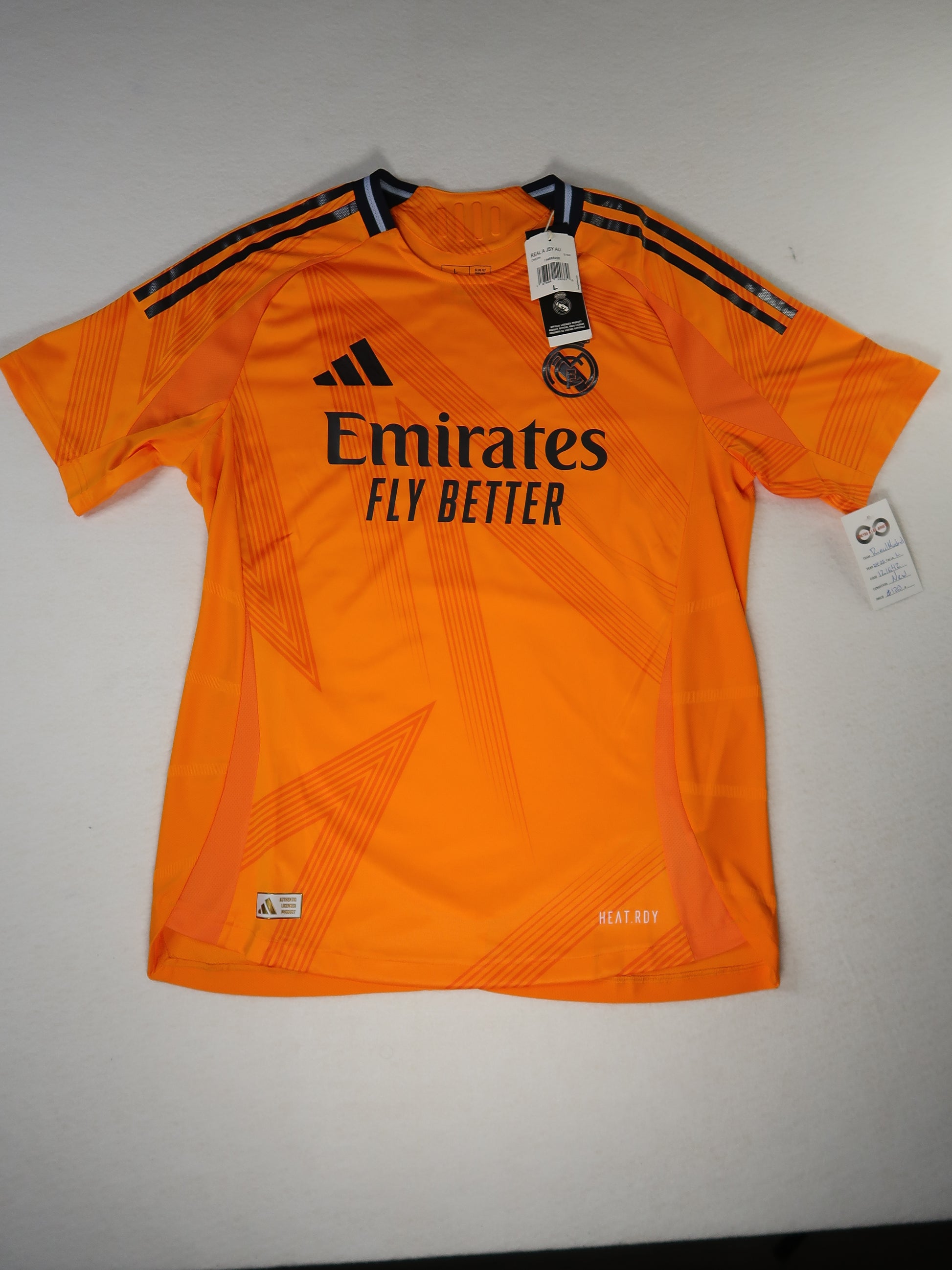 2024-25 Real Madrid away jersey front, orange with Emirates Fly Better sponsor