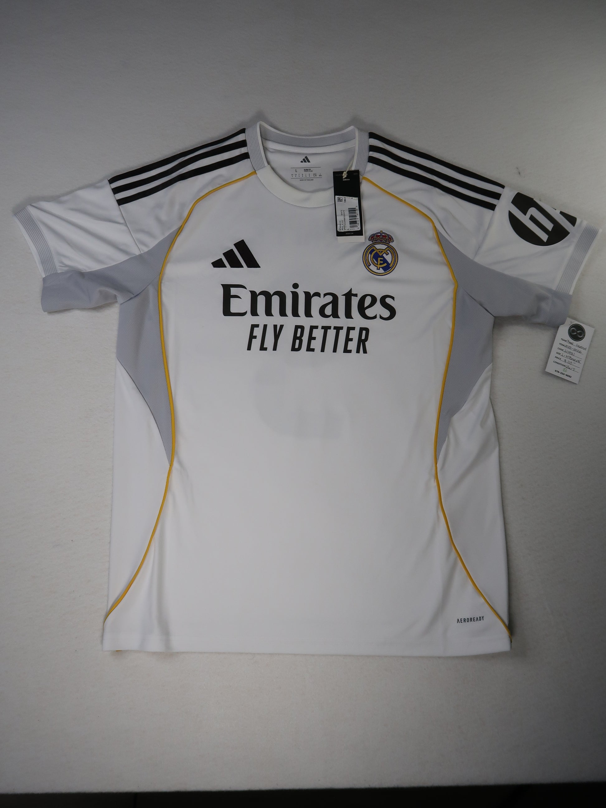 2025-26 Real Madrid home jersey front, white with gold piping and Emirates sponsor